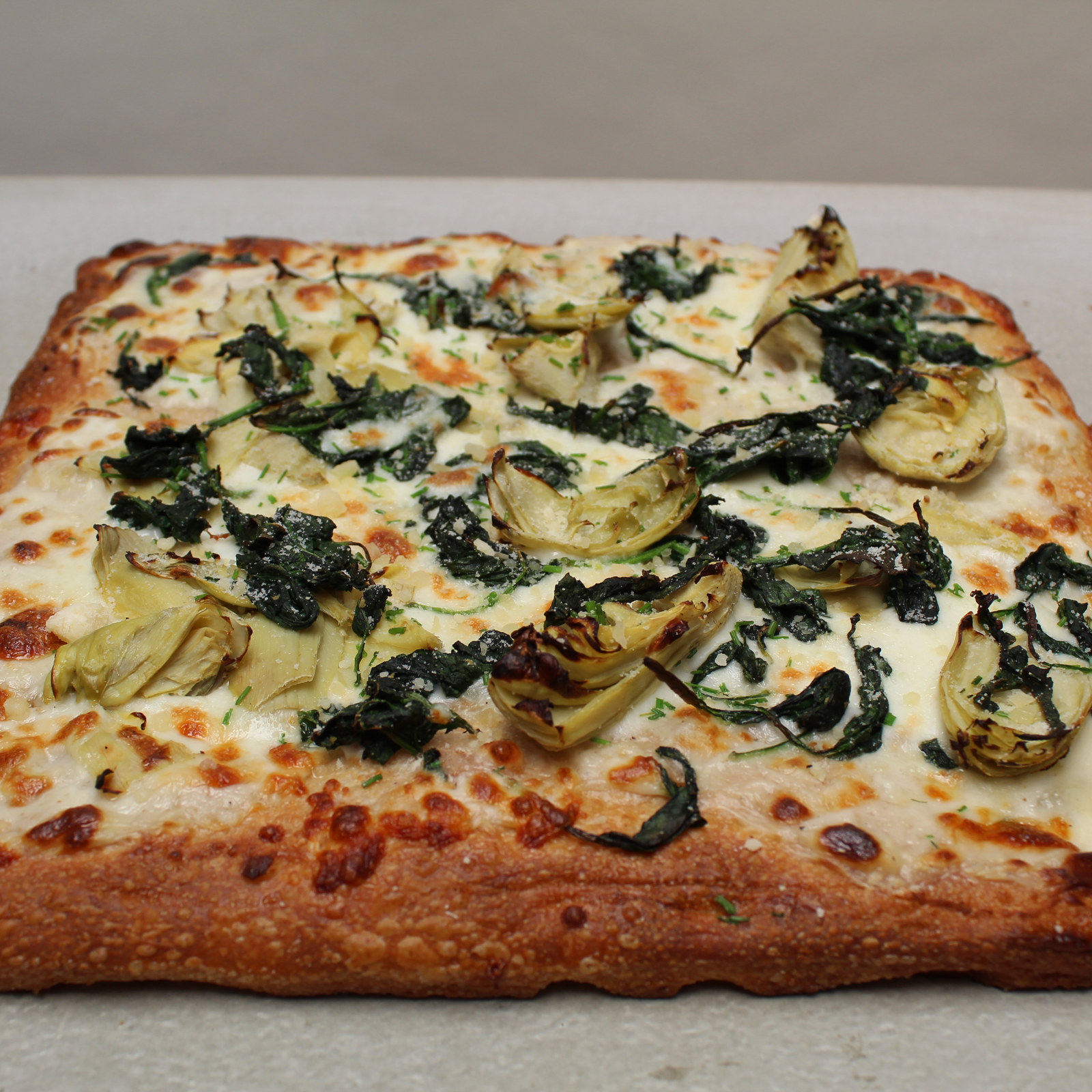 Spinach and artichoke square pizza